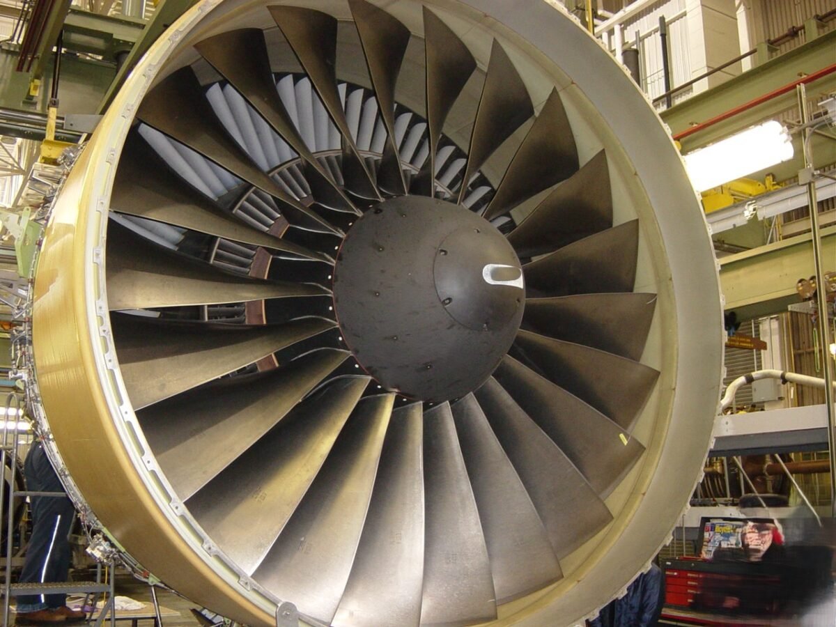 Front view of the fan of a Pratt & Whitney PW4077 turbofan engine, a member of the PW4000 family, in a hangar