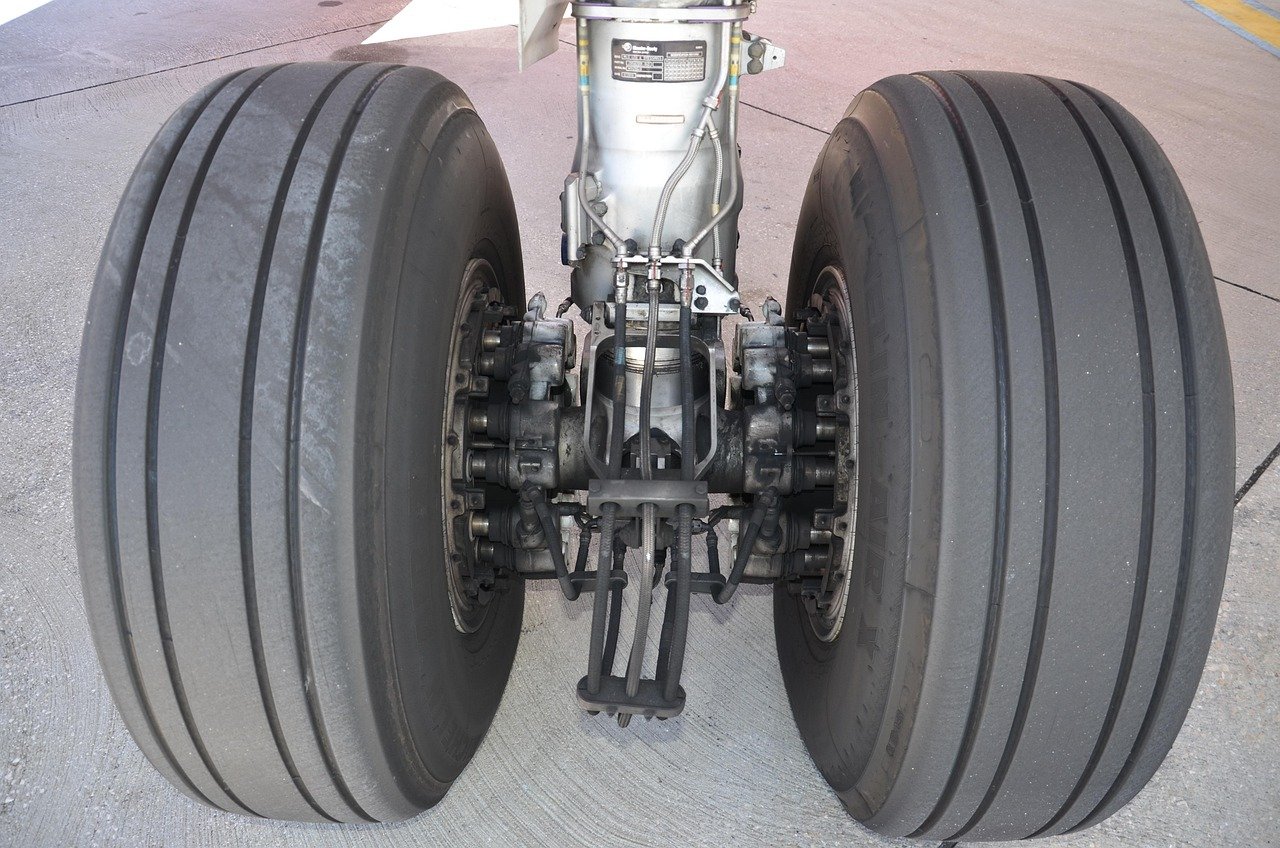 Aircraft landing gear close-up showing mechanical components