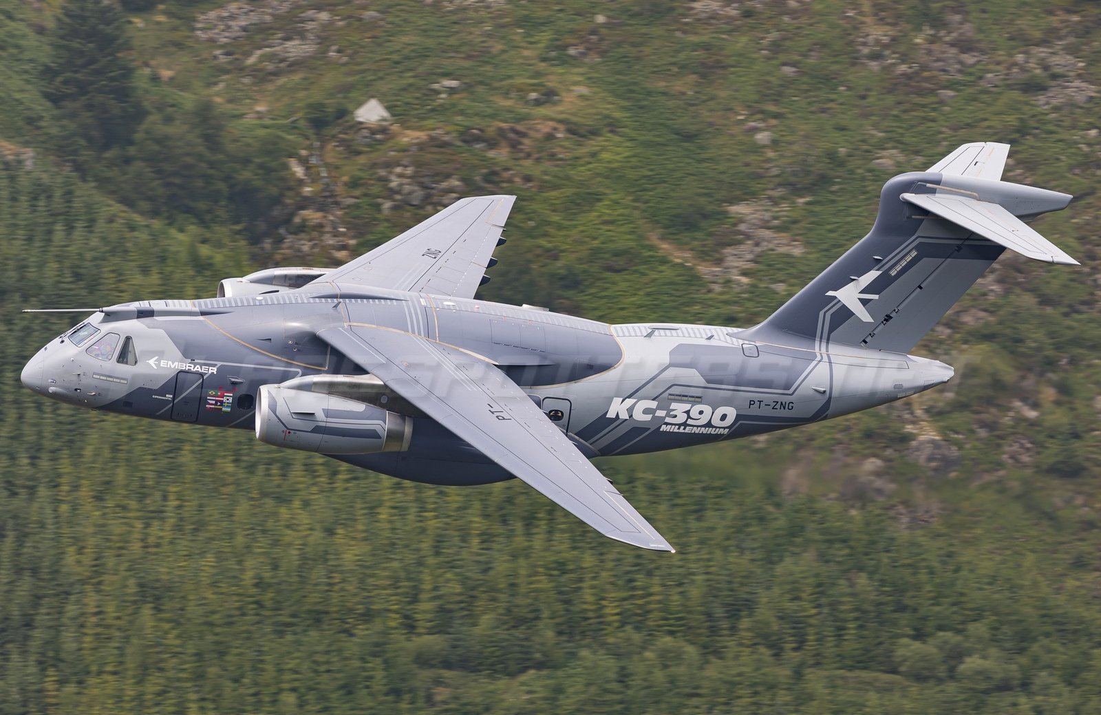 Embraer C-390 Millennium in flight over landscape