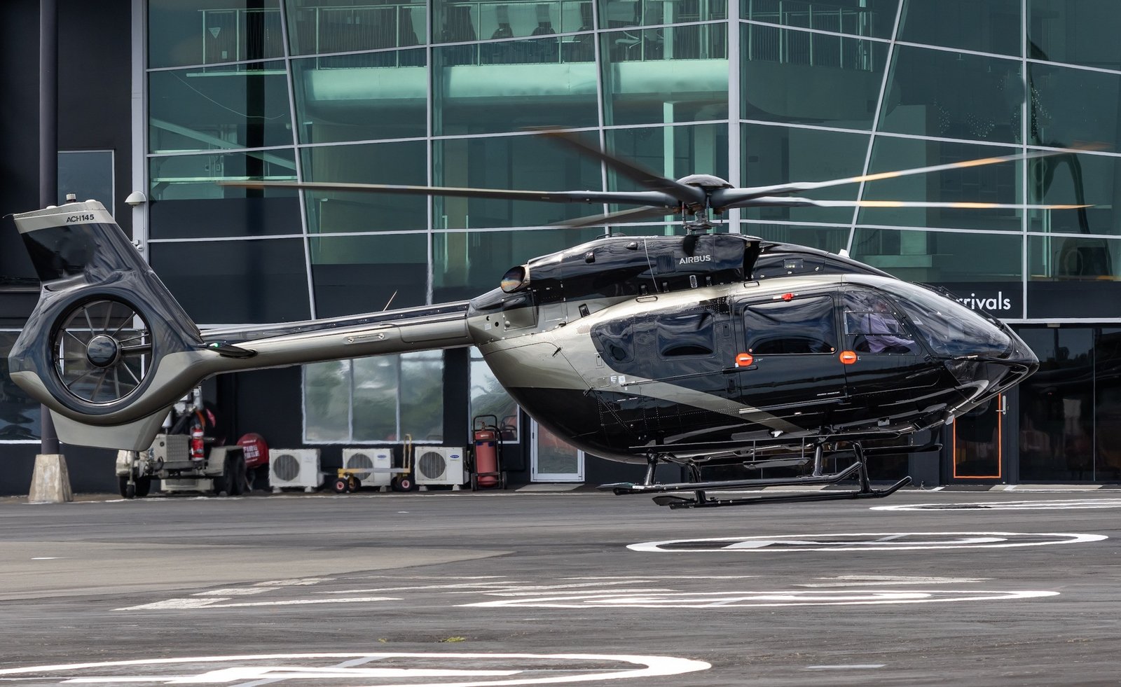 Airbus H145 helicopter in flight, showcasing its modern design and sleek profile.