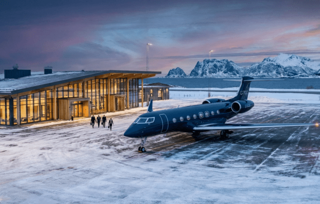 Luxury private jet at modern Scandinavian airport terminal during Nordic twilight with mountains in background - Safe Fly Aviation Northern Europe guide