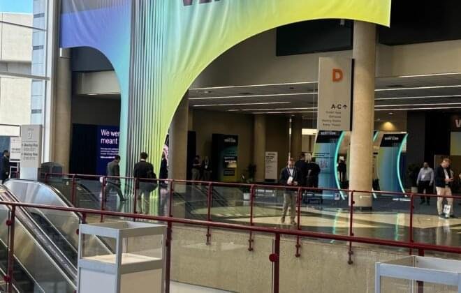 A panoramic view of VERTICON 2025 at the Kay Bailey Hutchison Convention Center, showcasing helicopter displays, aviation technology exhibits, and industry professionals networking at the global vertical aviation event