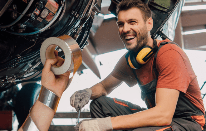 Aircraft maintenance engineers performing nighttime exterior check with speed tape on wing fairing