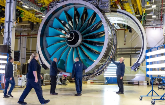 Aviation engineer inspecting aircraft engine at maintenance facility